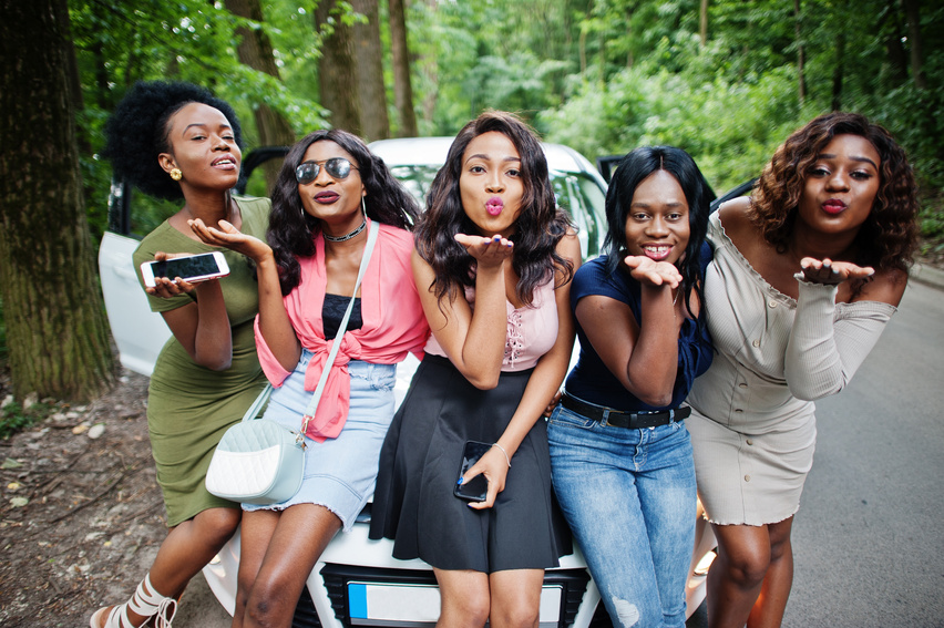 Group of five happy african american traveler girls